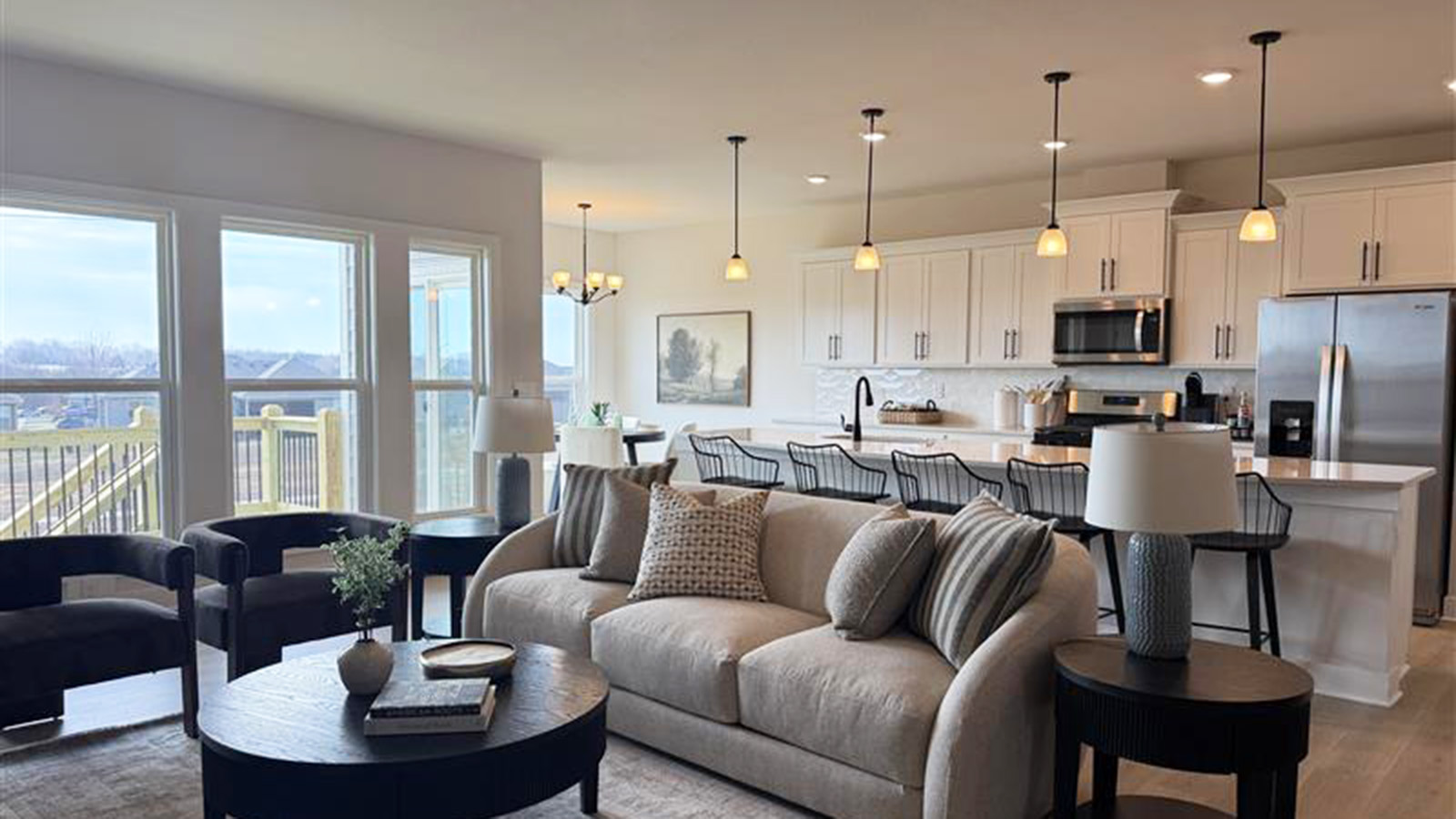 Living room with large windows and stone fireplace