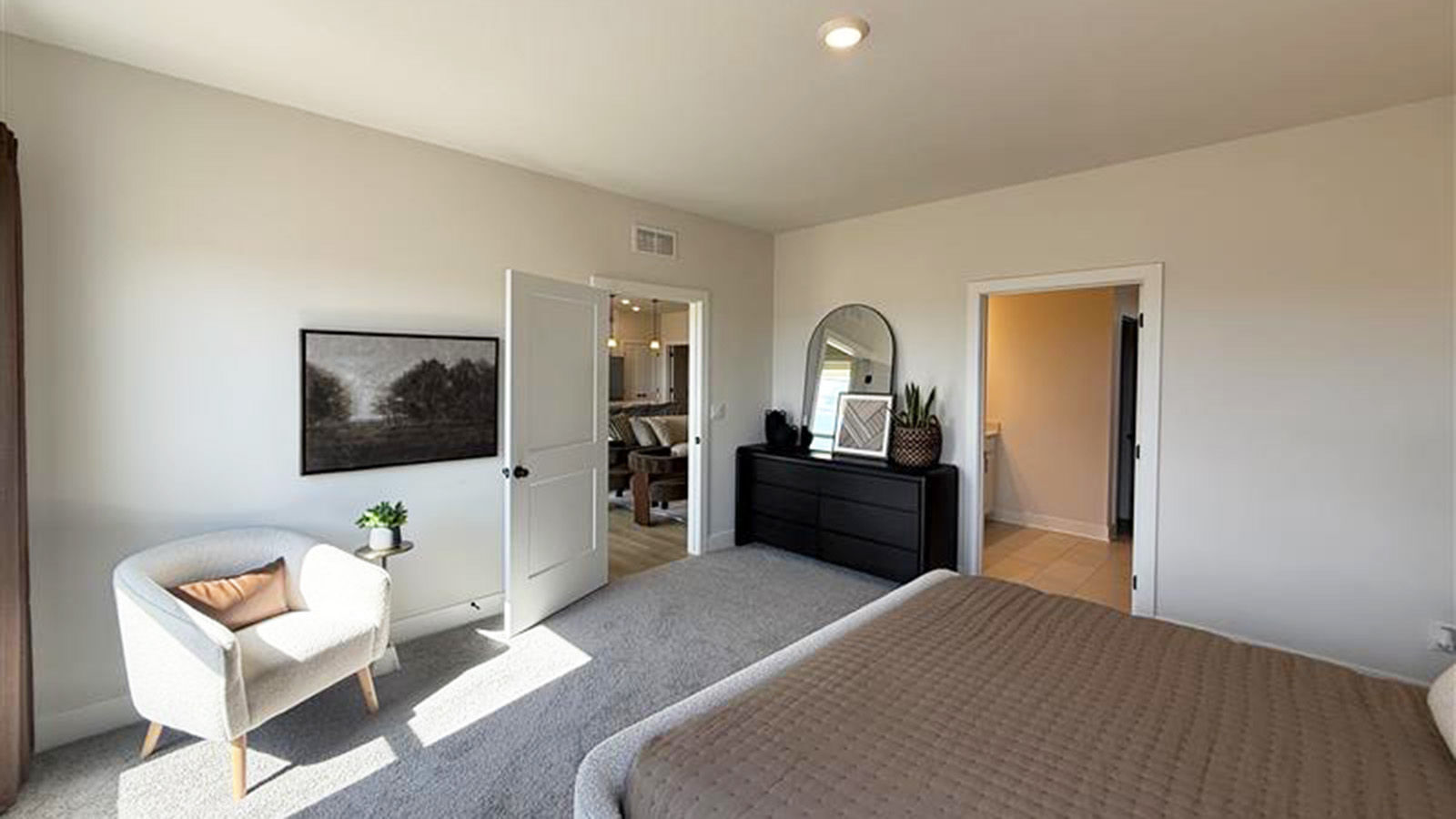 Carpeted primary bedroom with large windows