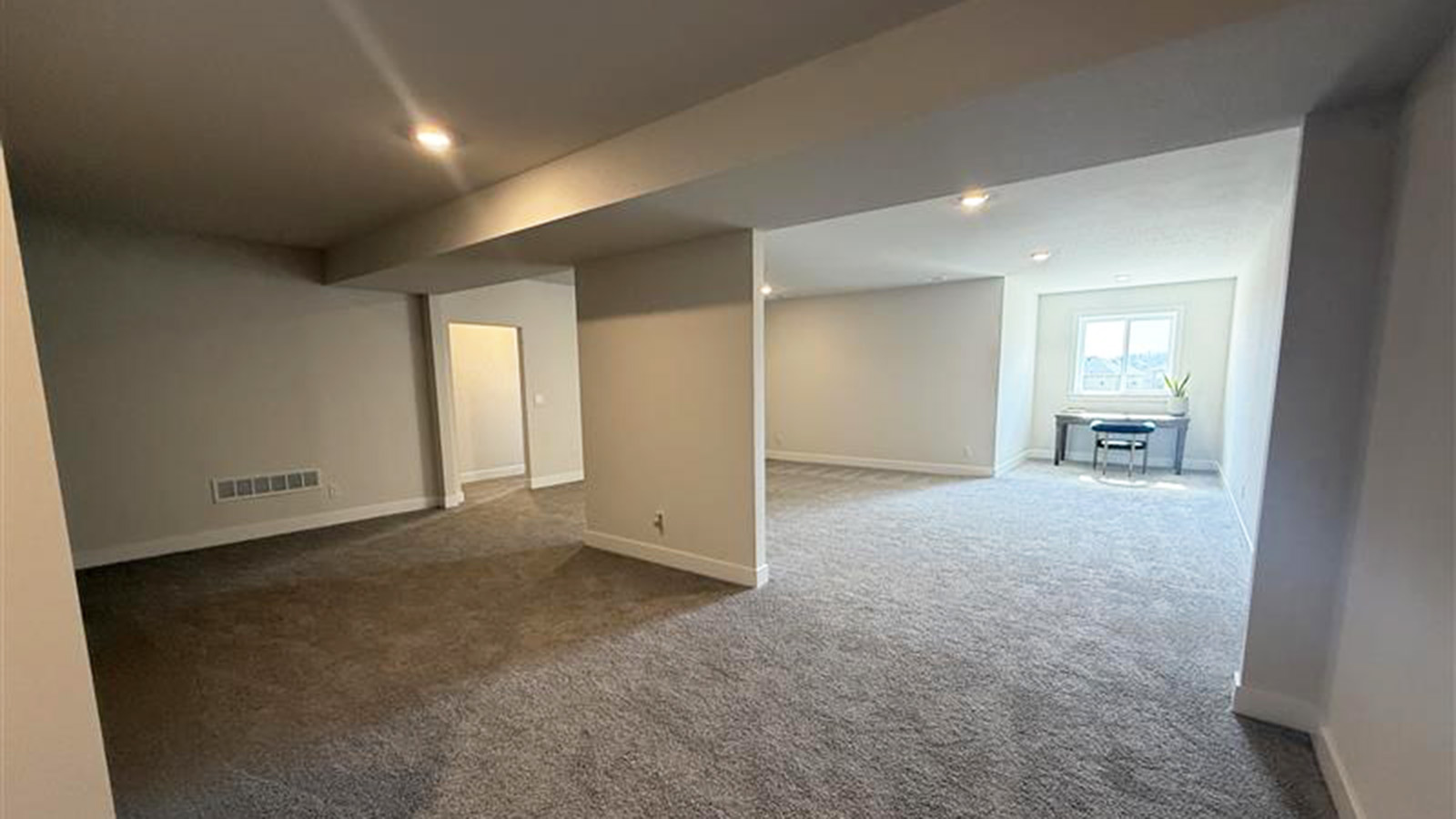 Finished basement with carpet and large windows
