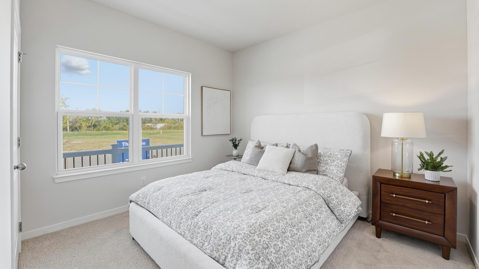 Carpeted bedroom with large window