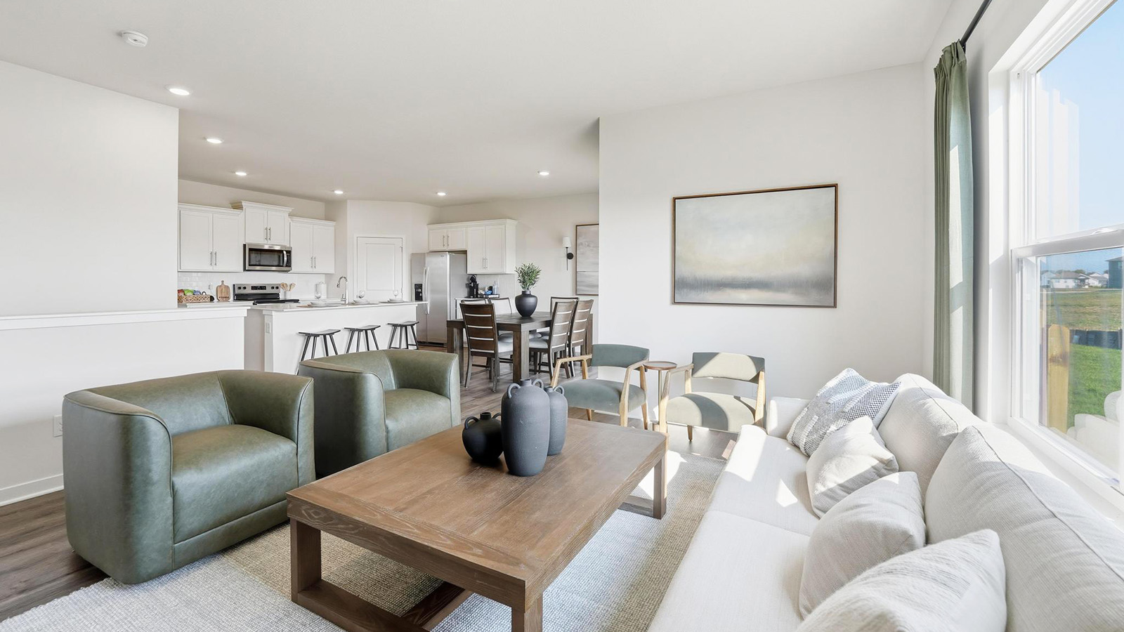 Living room beside kitchen, with electric fireplace and large window