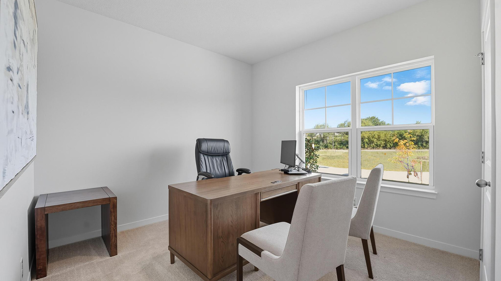 Carpeted bedroom with large windows