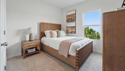 Carpeted bedroom with large windows