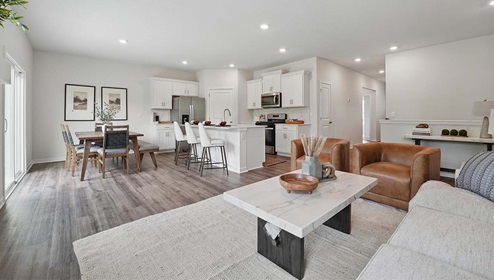 Living room with electric fireplace, and large windows