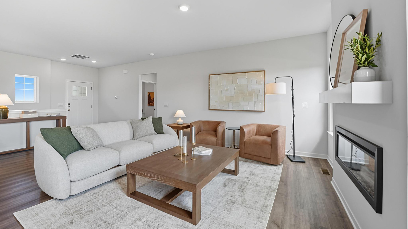 Living room with electric fireplace, and large windows