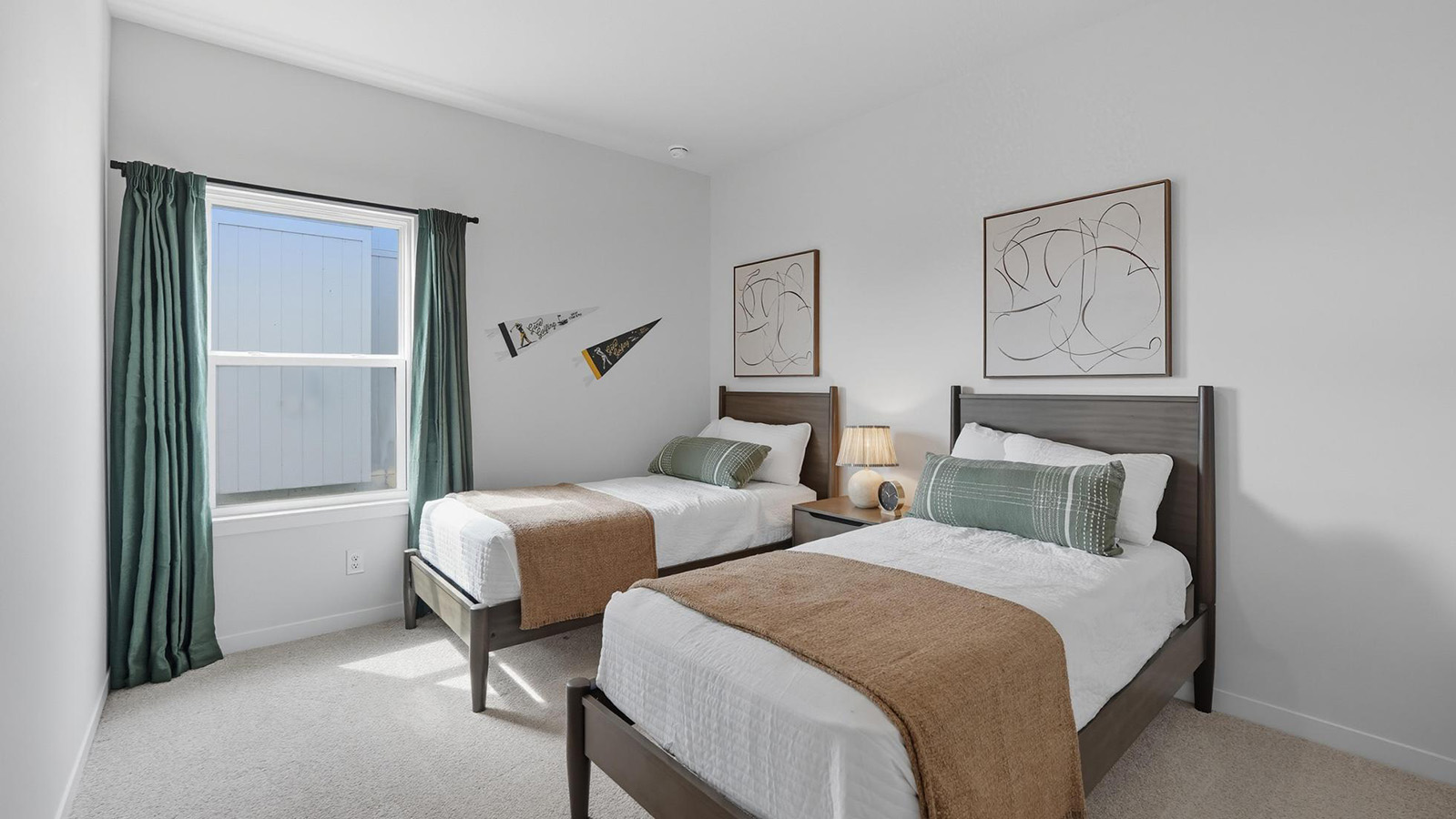 Carpeted bedroom with large windows.