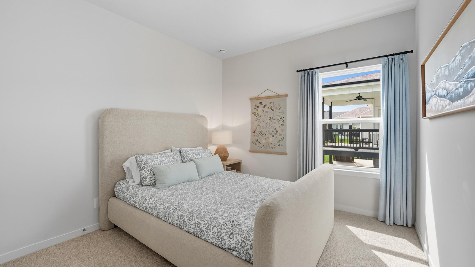 Carpeted bedroom with large windows