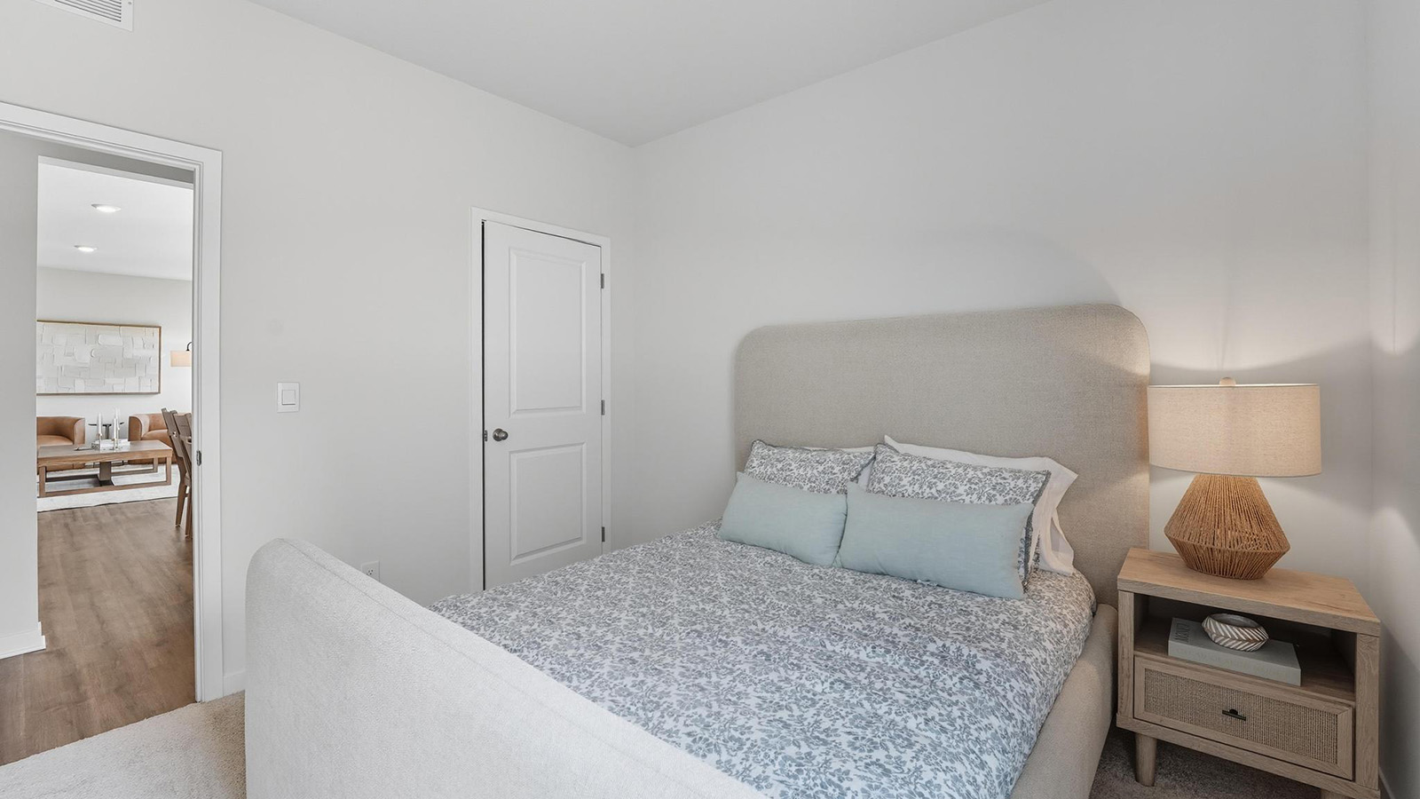 Carpeted bedroom with large windows