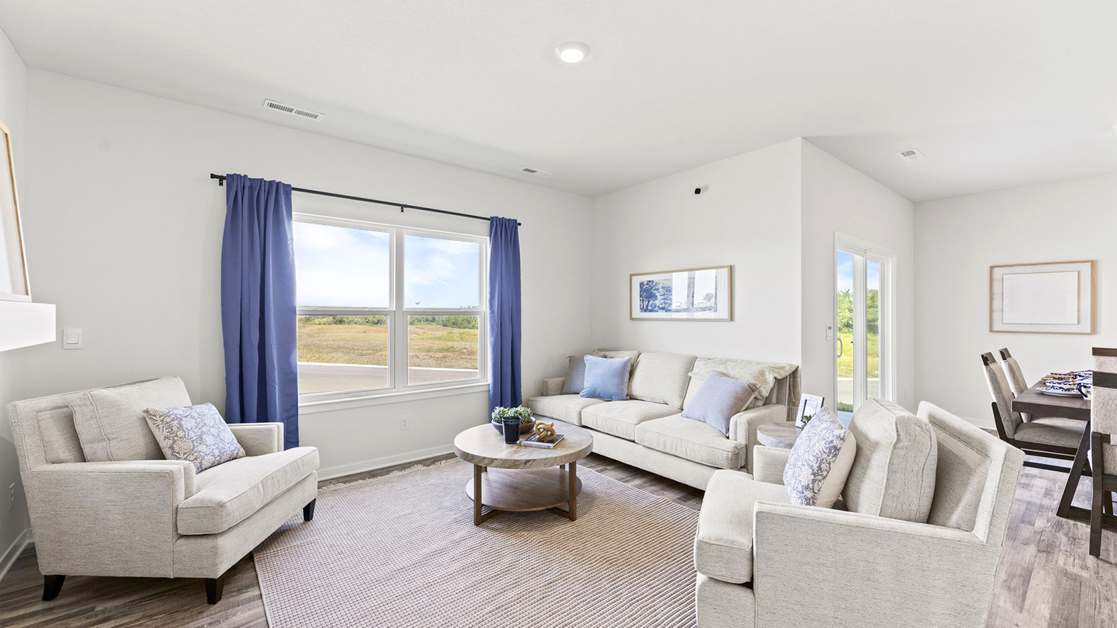 Living room beside kitchen, with electric fireplace and large window