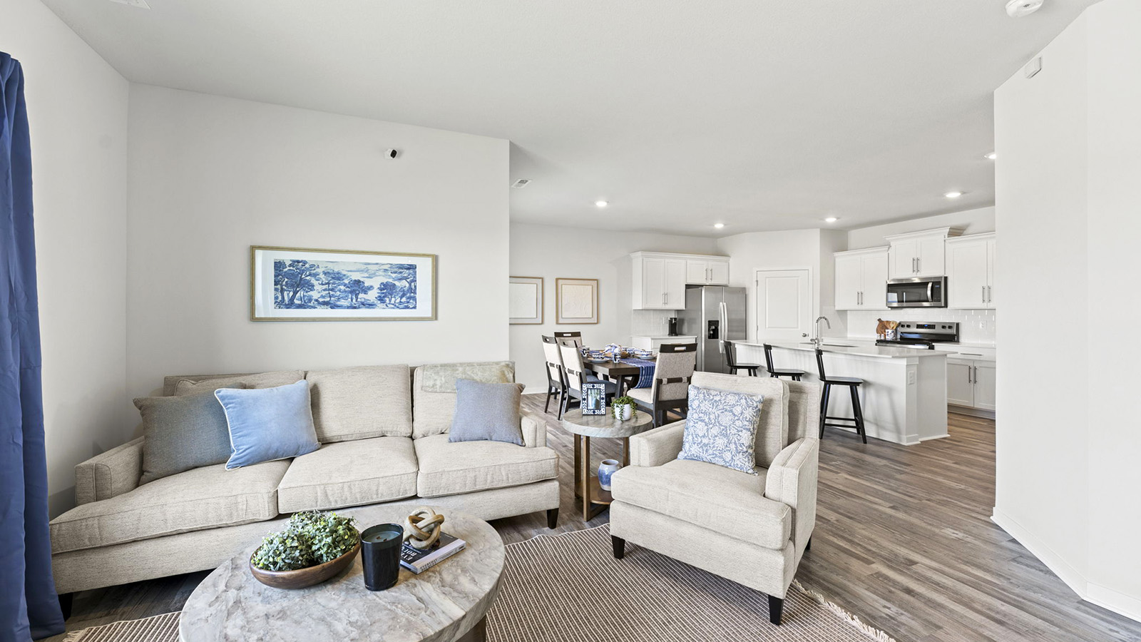 Living room beside kitchen, with electric fireplace and large window