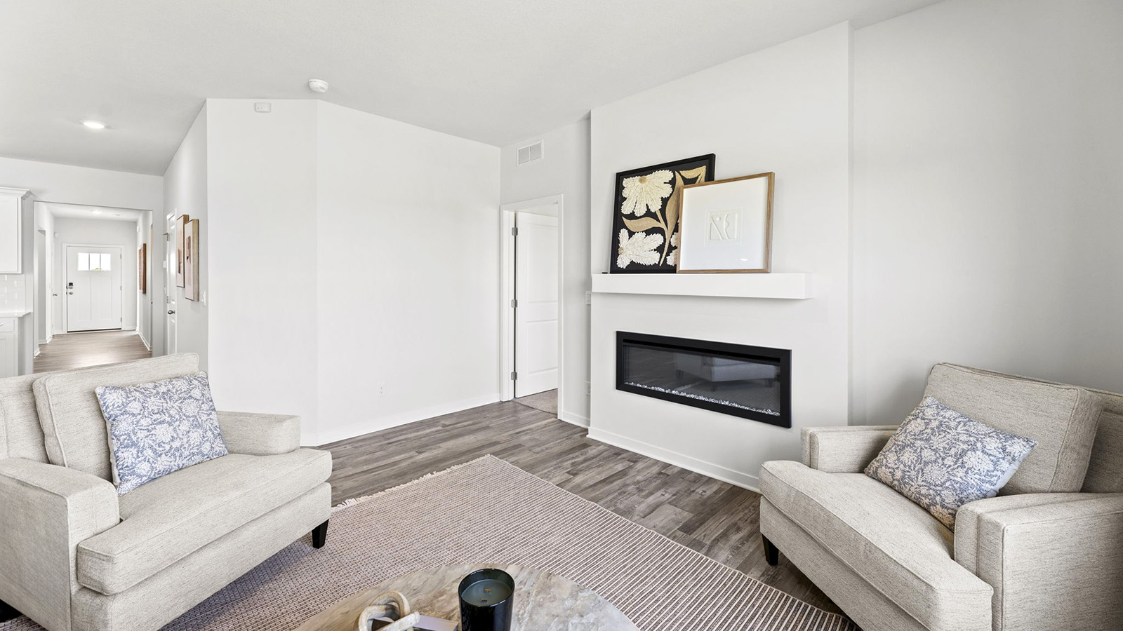 Living room beside kitchen, with electric fireplace and large window