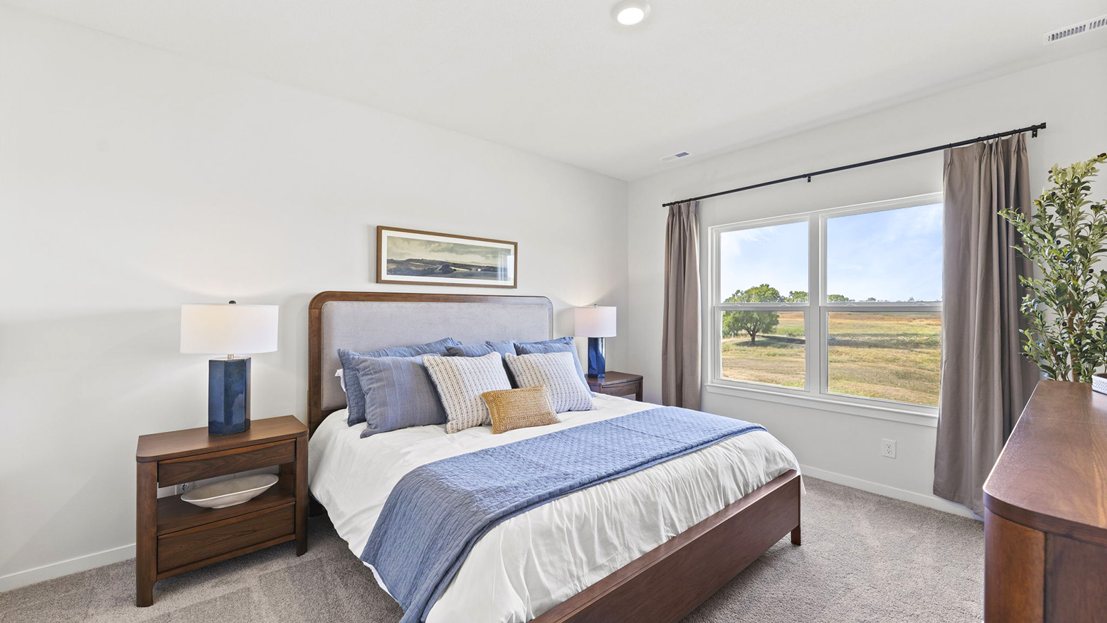 Primary bedroom with carpet, and large windows
