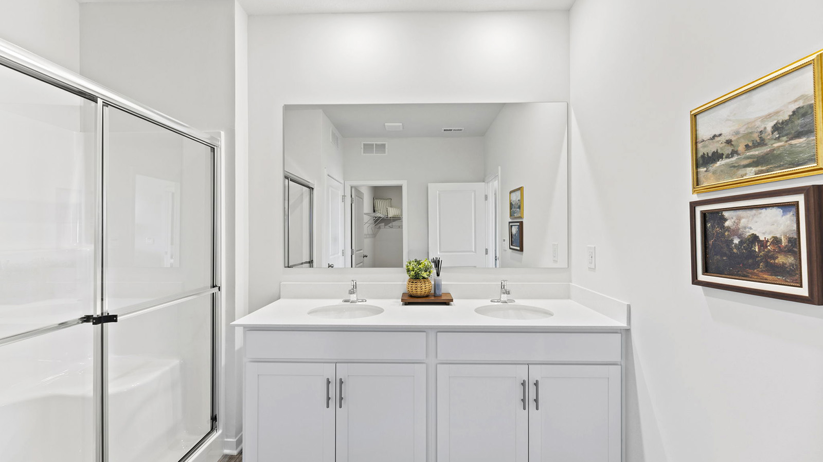 Bathroom with double vanity and shower with glass door