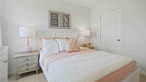 Carpeted bedroom with large window. New Homes in Kansas City, Missouri