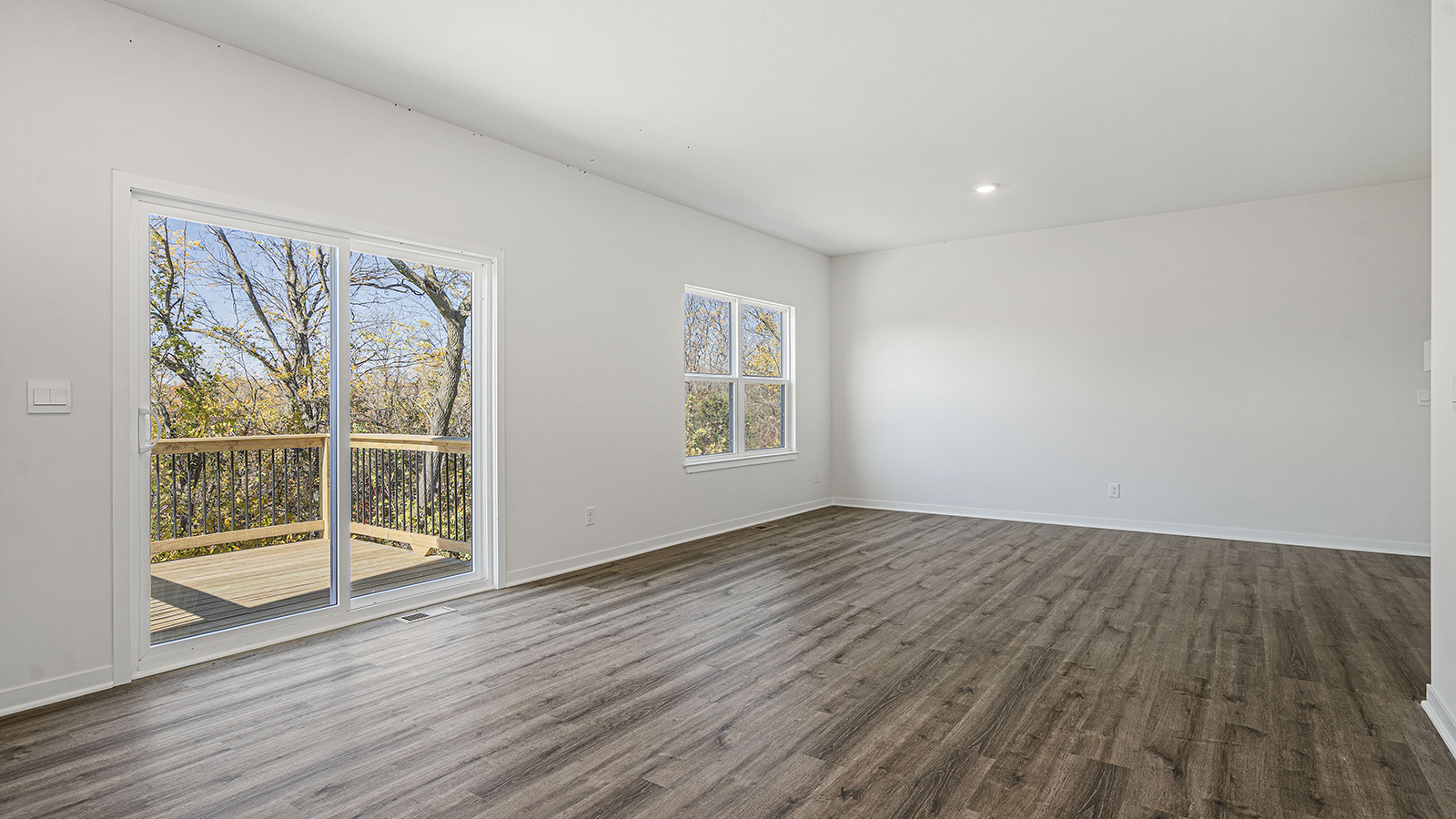 Open concept living area with electric fireplace and large window