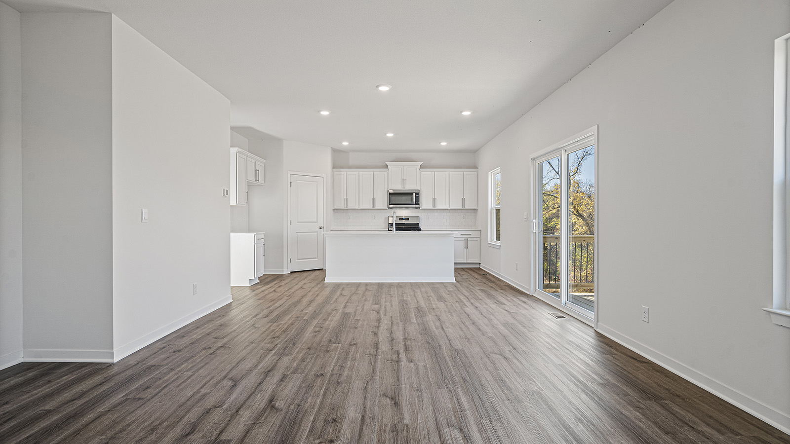 Open concept living area with electric fireplace and large window