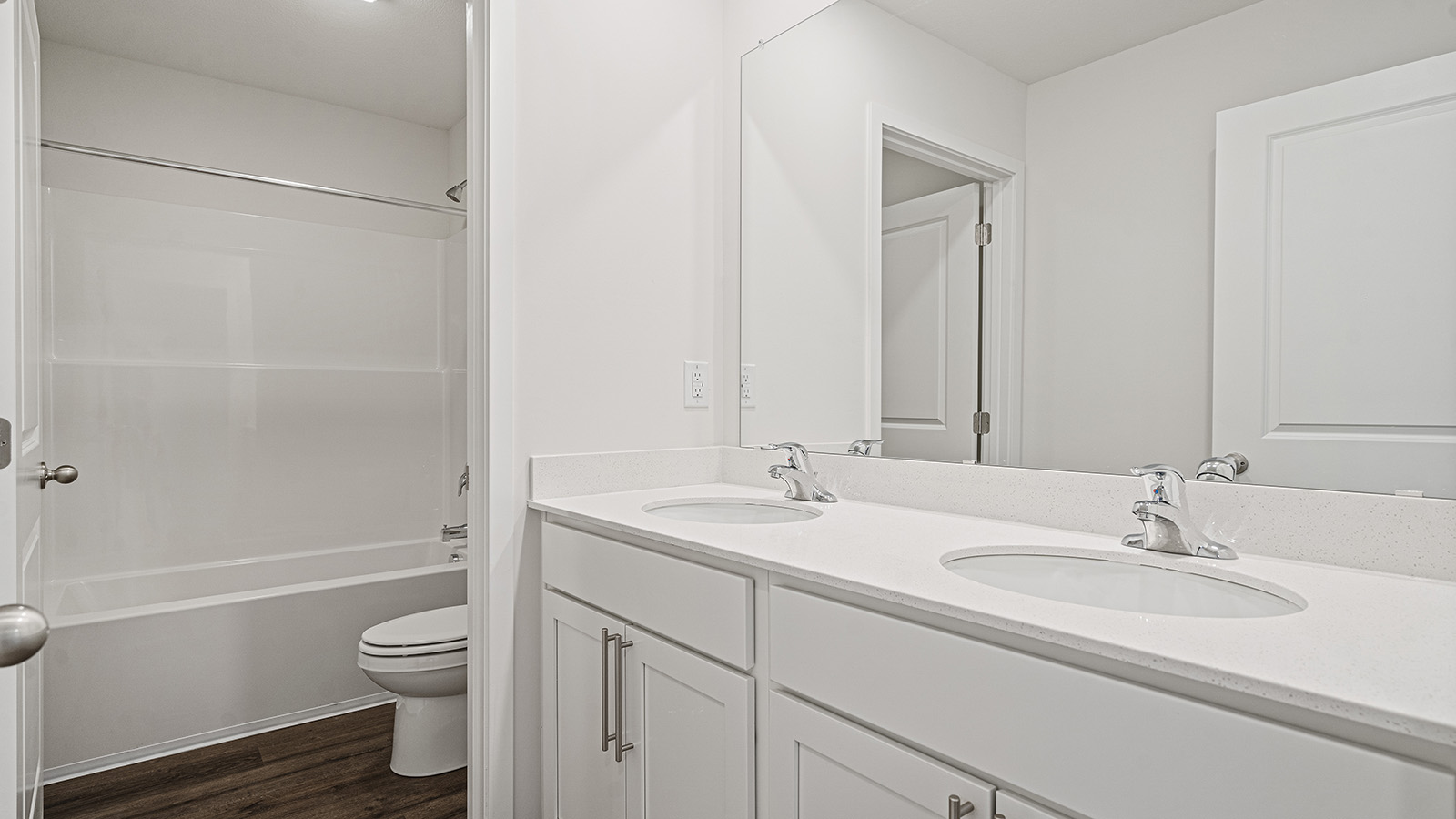 Bathroom with double vanity and separate toilet and shower area