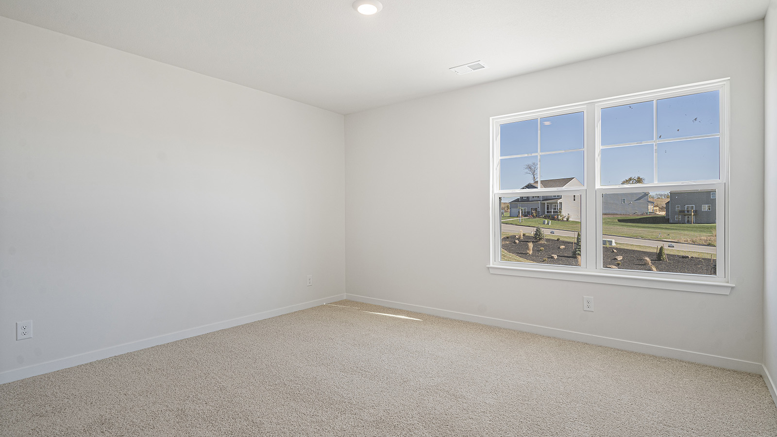 Carpeted bedroom with large window