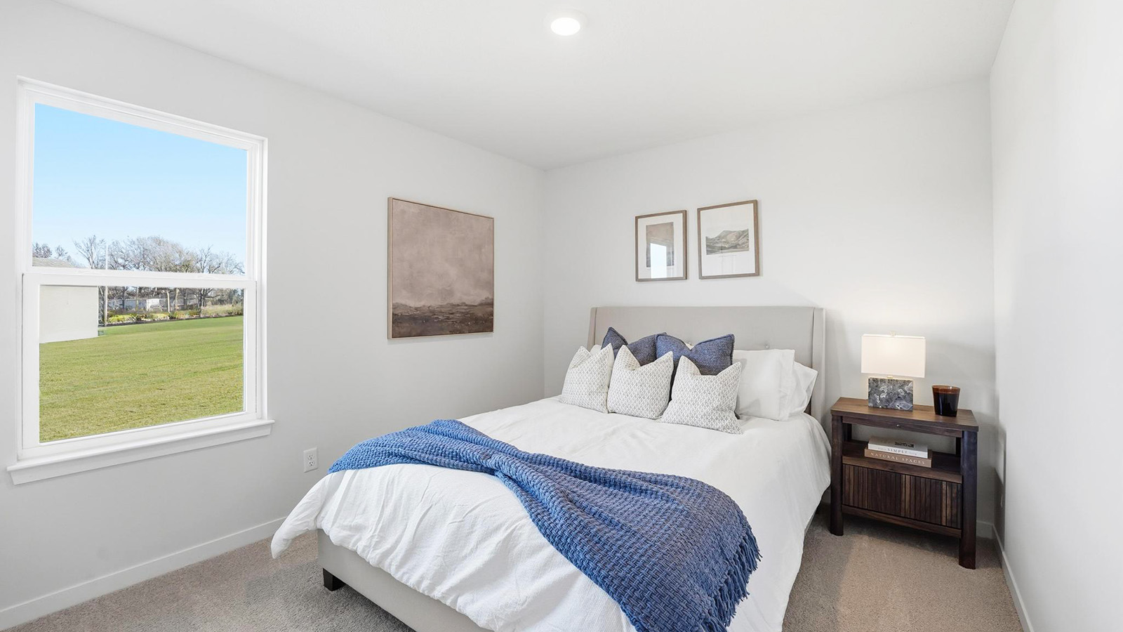 Carpeted bedroom with large windows