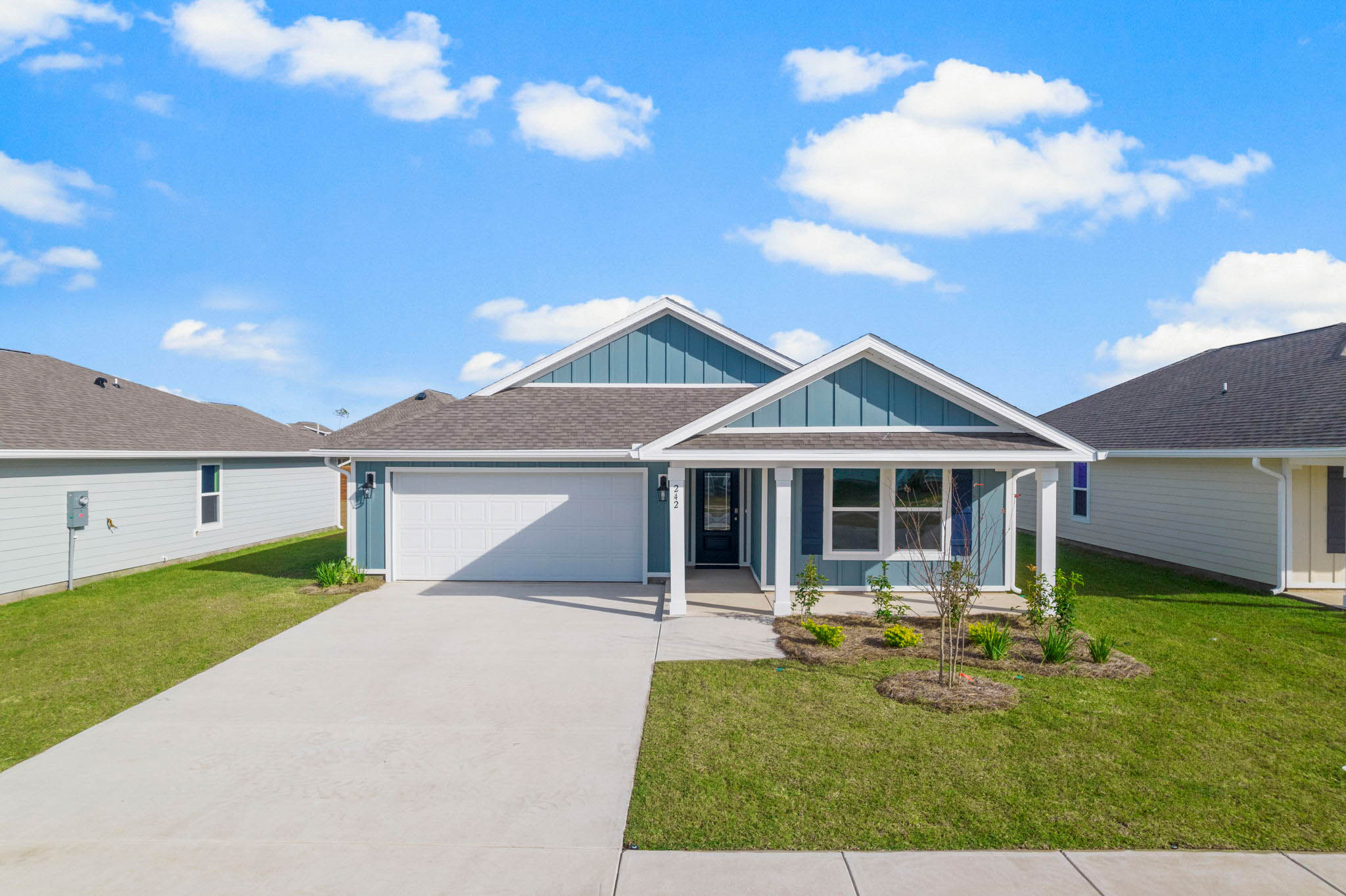 Blue Lakeside five bedroom floorplan with luscious green grass and blue sky in background