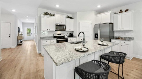 Kitchen with large island and white cabinets