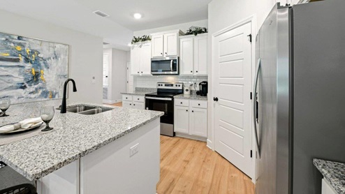 Corner kitchen shot with island and large corner pantry