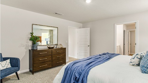 expansive primary bedroom features a luxurious bathroom with a walk-in shower, double vanities, and an oversized walk-in closet