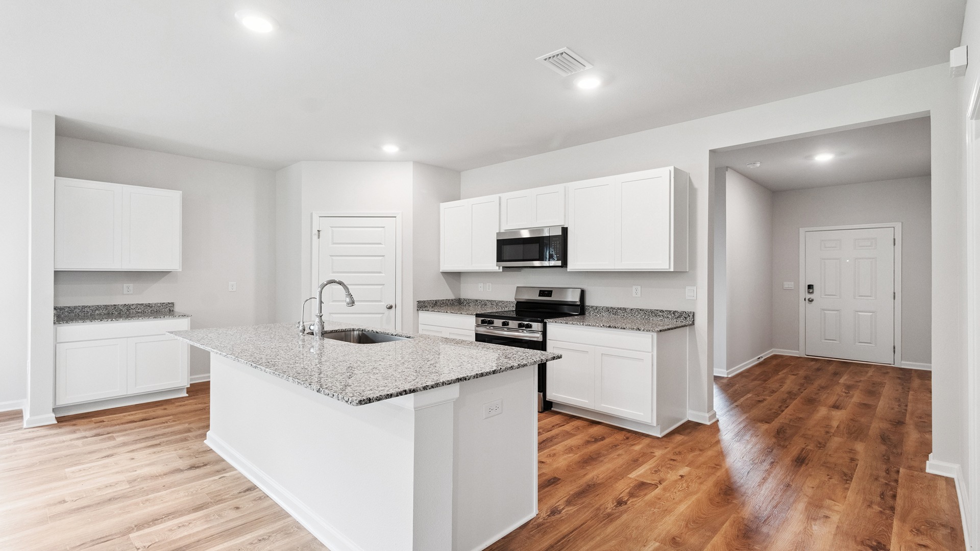 Kitchen with white cabinets and granite counters