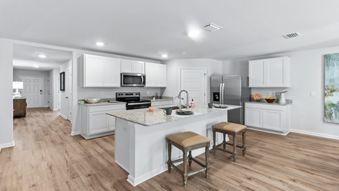 Large kitchen with white cabinets