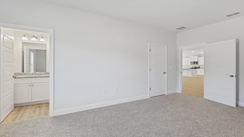 Empty bedroom with bathroom connected