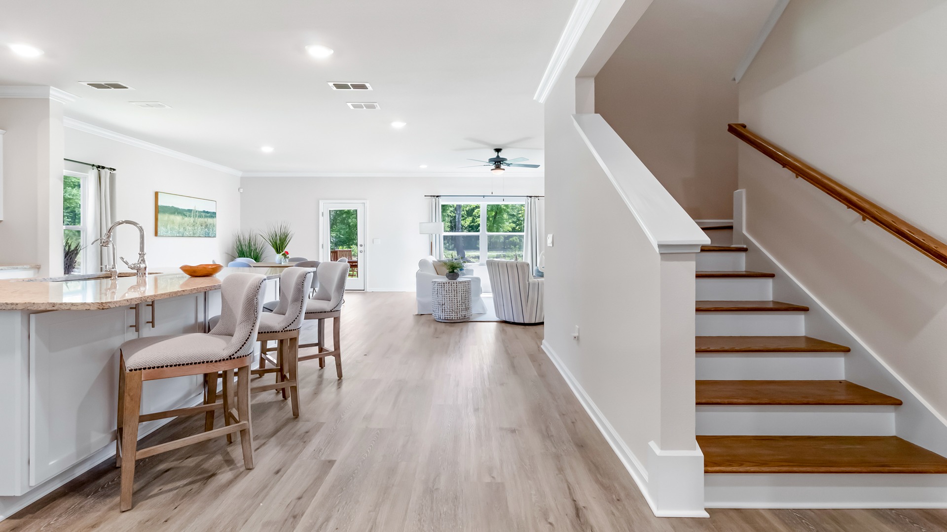 Entry into the model home with kitchen and stairs
