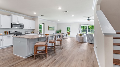 Entry into the model home with kitchen and stairs