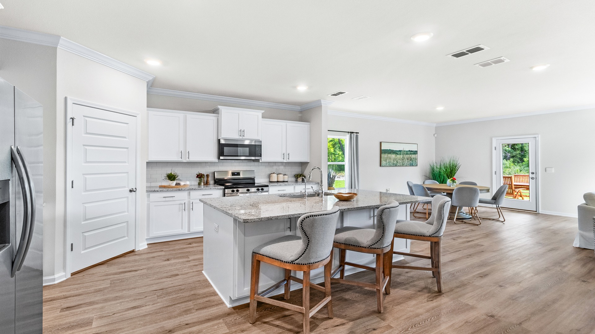 Kitchen with white cabinets and large granite island