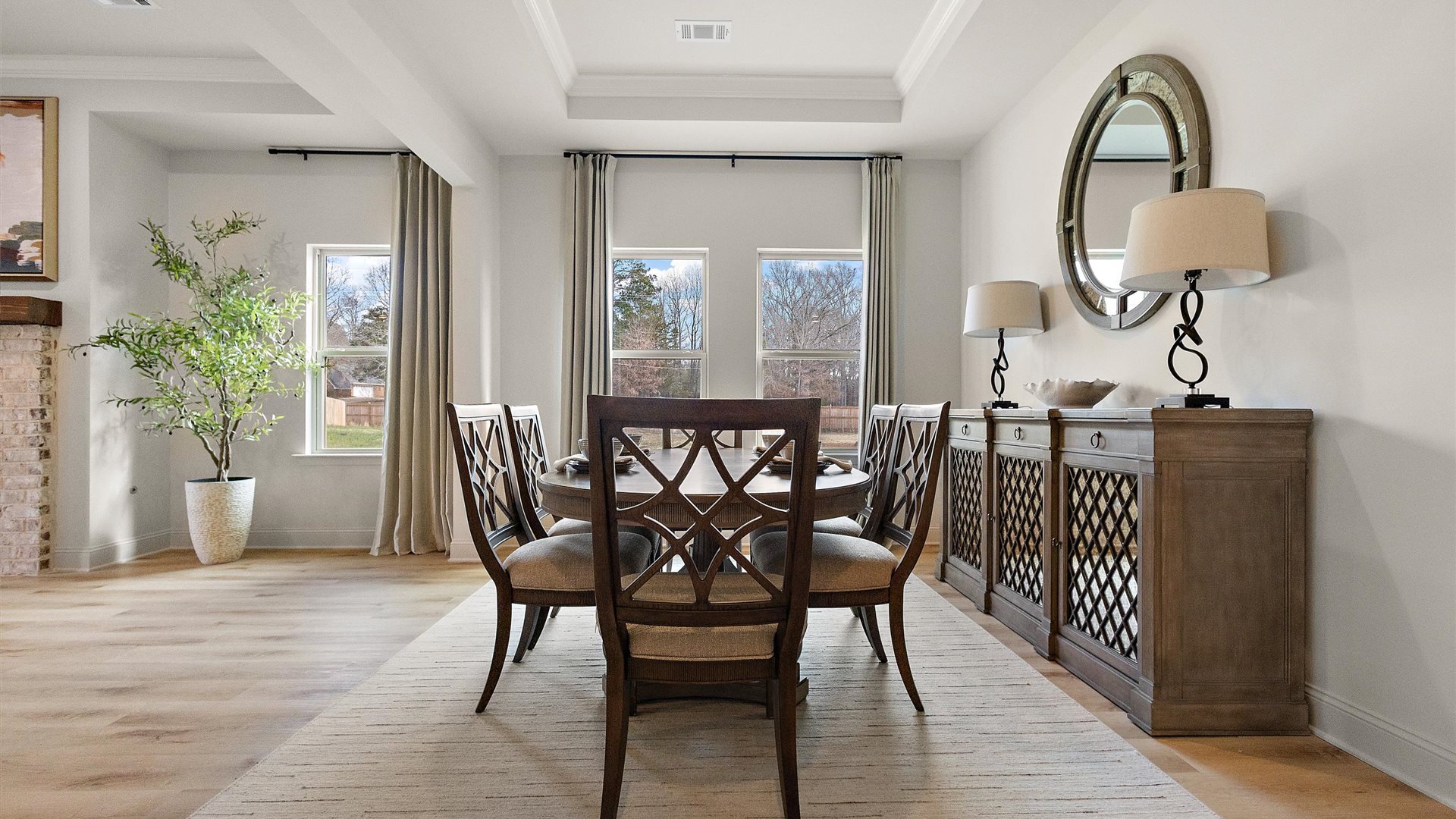 Dining room with natural light, open outdoor access and seamless flow continuing to front foyer and kitchen access