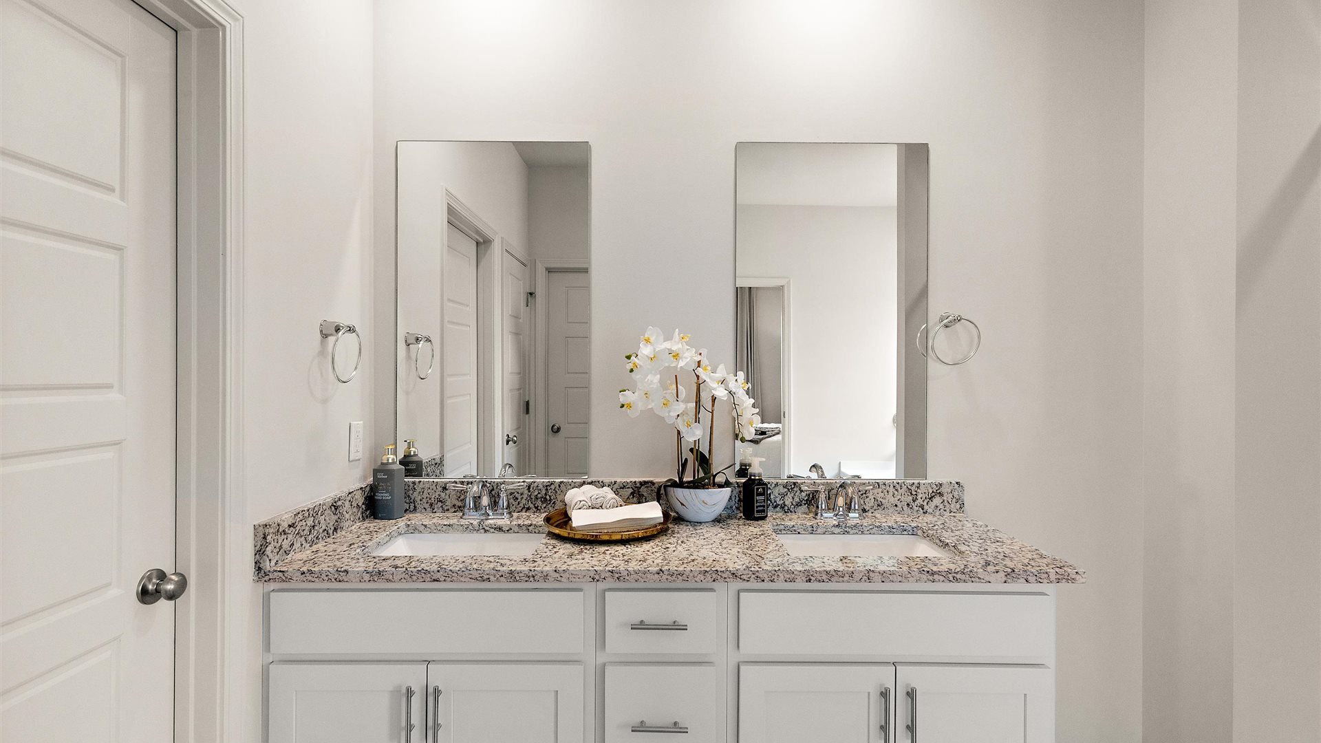 Owner’s en suite view in our new home combines style, like double vanity, mirror, a walk-in closet, in spa-inspired comfort