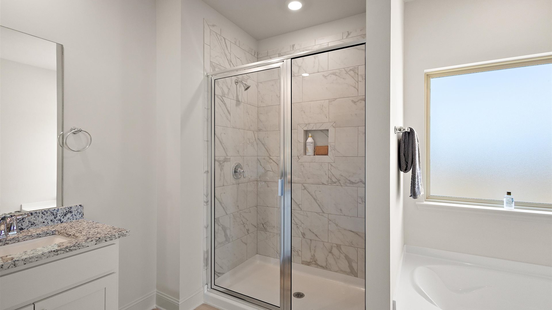 Owner’s en suite adds stylish, spa-inspired design, access to the primary bedroom, walk-in shower, walk-in closet