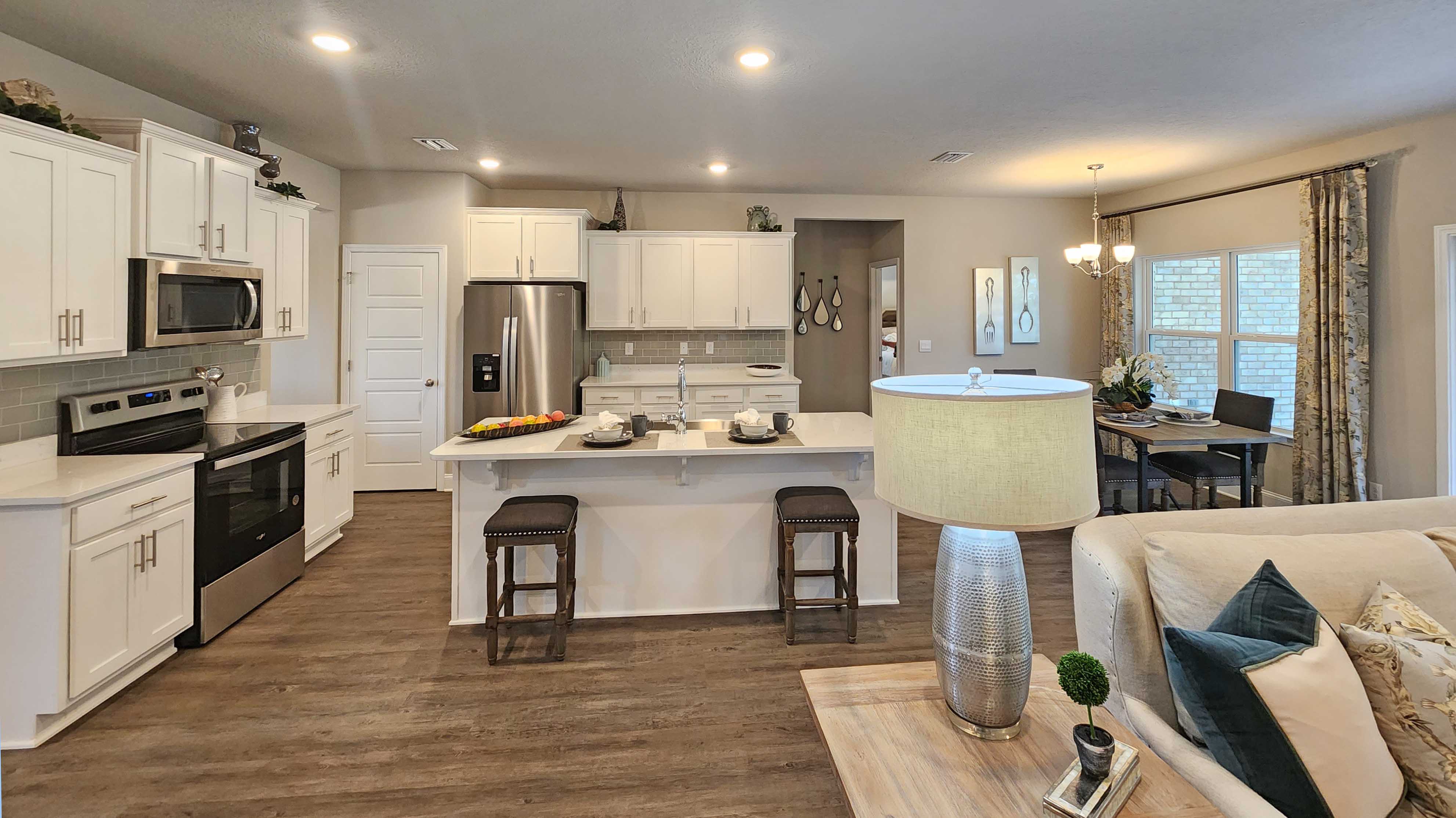kitchen overlooking the living space with hardwood floors and recessed lighting