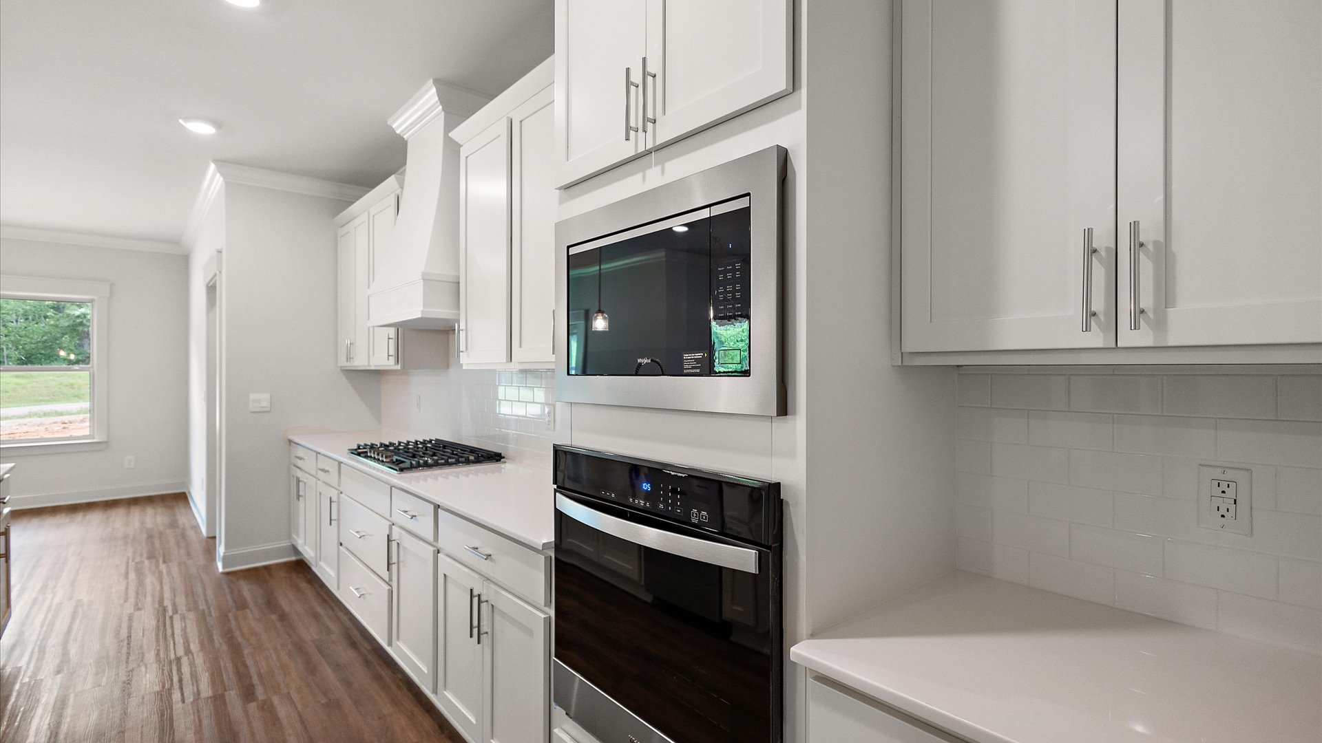 interior kitchen with white counter tops and cabinets