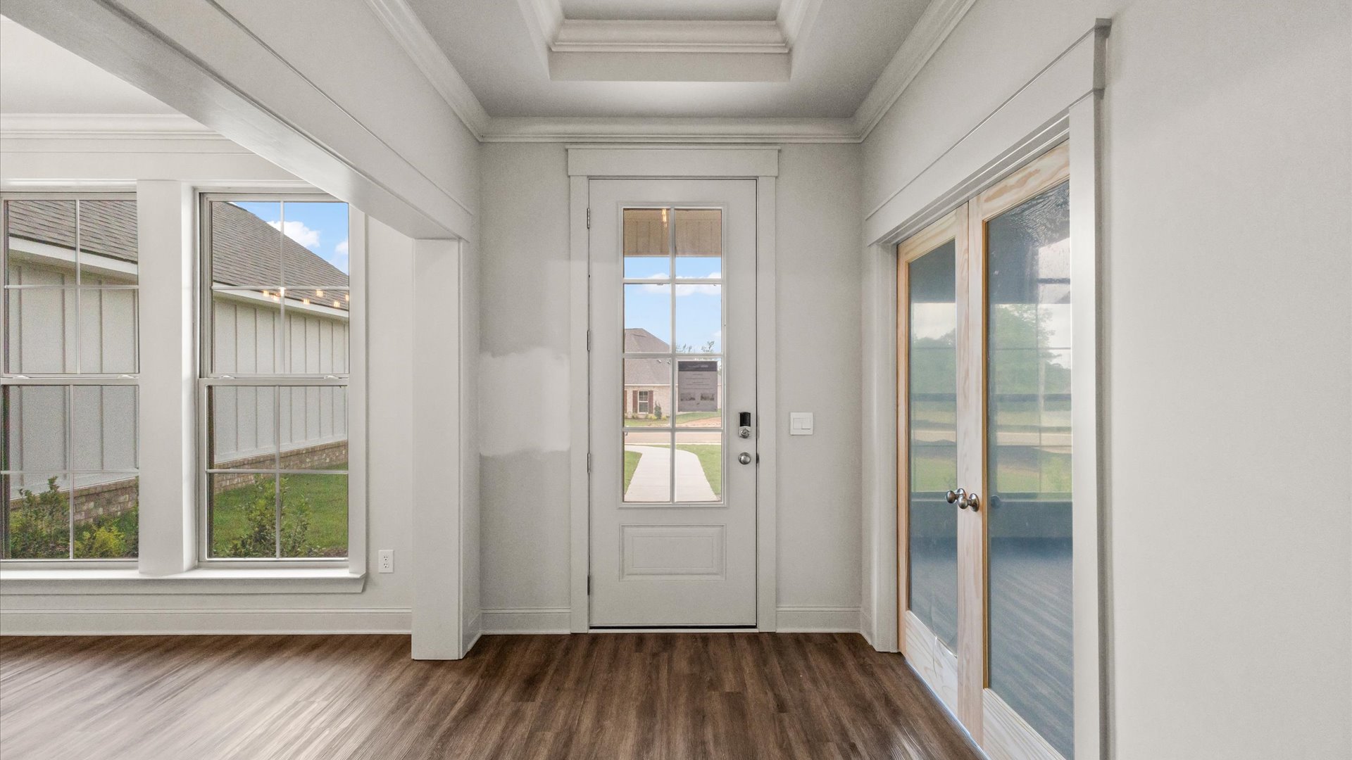Interior of front door entry way with many windows t