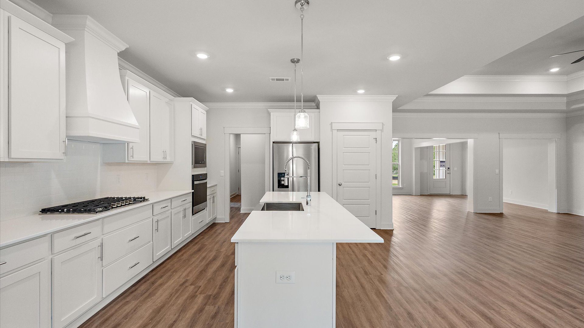 interior kitchen with white cabinets and central island