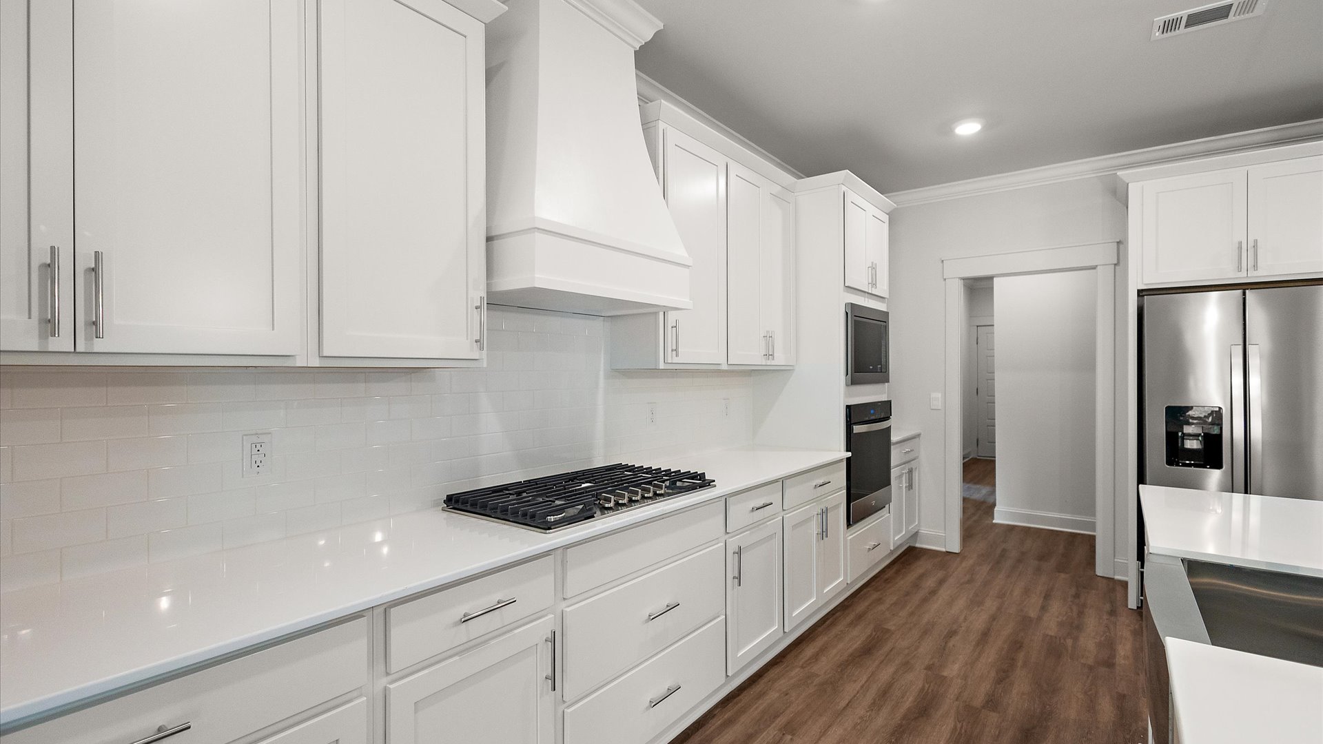 interior kitchen with white counter tops and cabinets