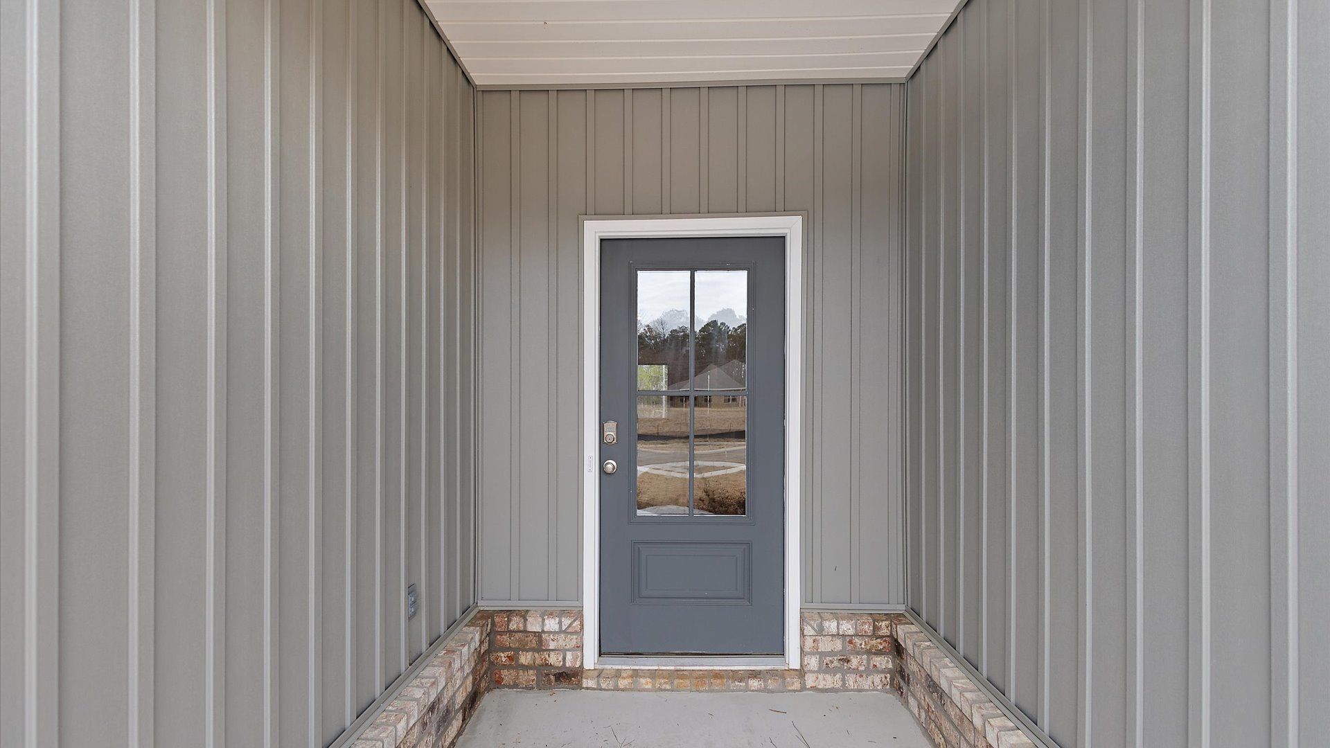Front entryway and foyer with hardwood floors and recessed lighting.