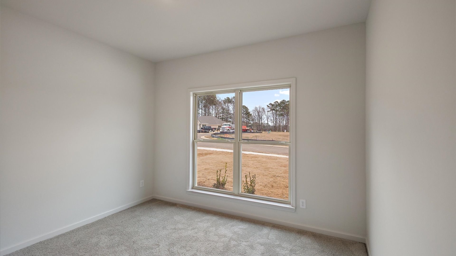 Additonal bedroom with carpeted floors, recessed lighting, and a window for natural light.