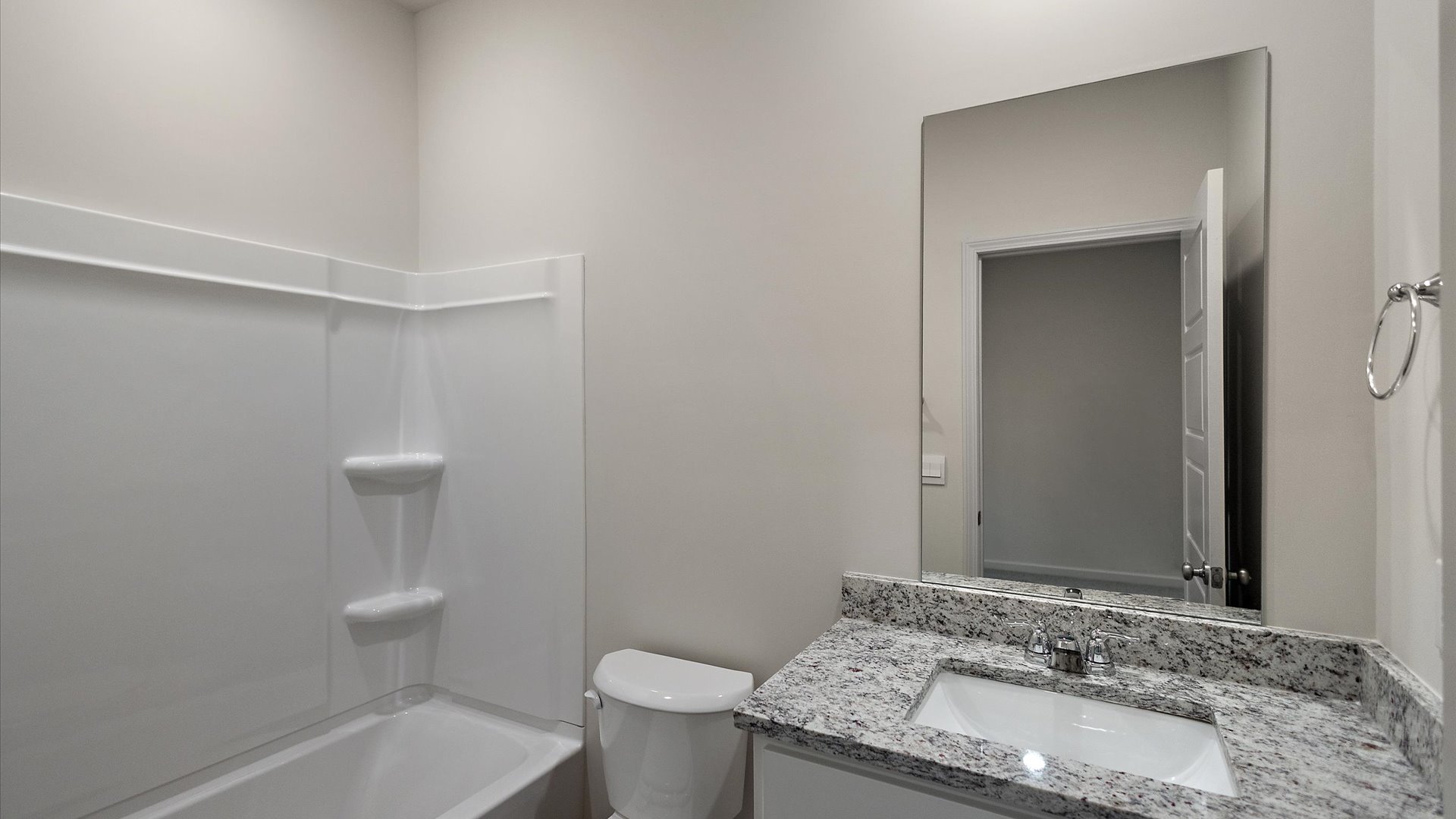 Single vanity bathroom with shower and tub combination.