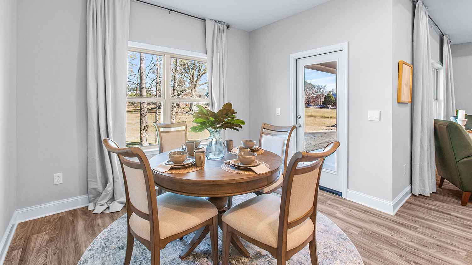 cozy dining area featuring a brown wooden table with four chairs