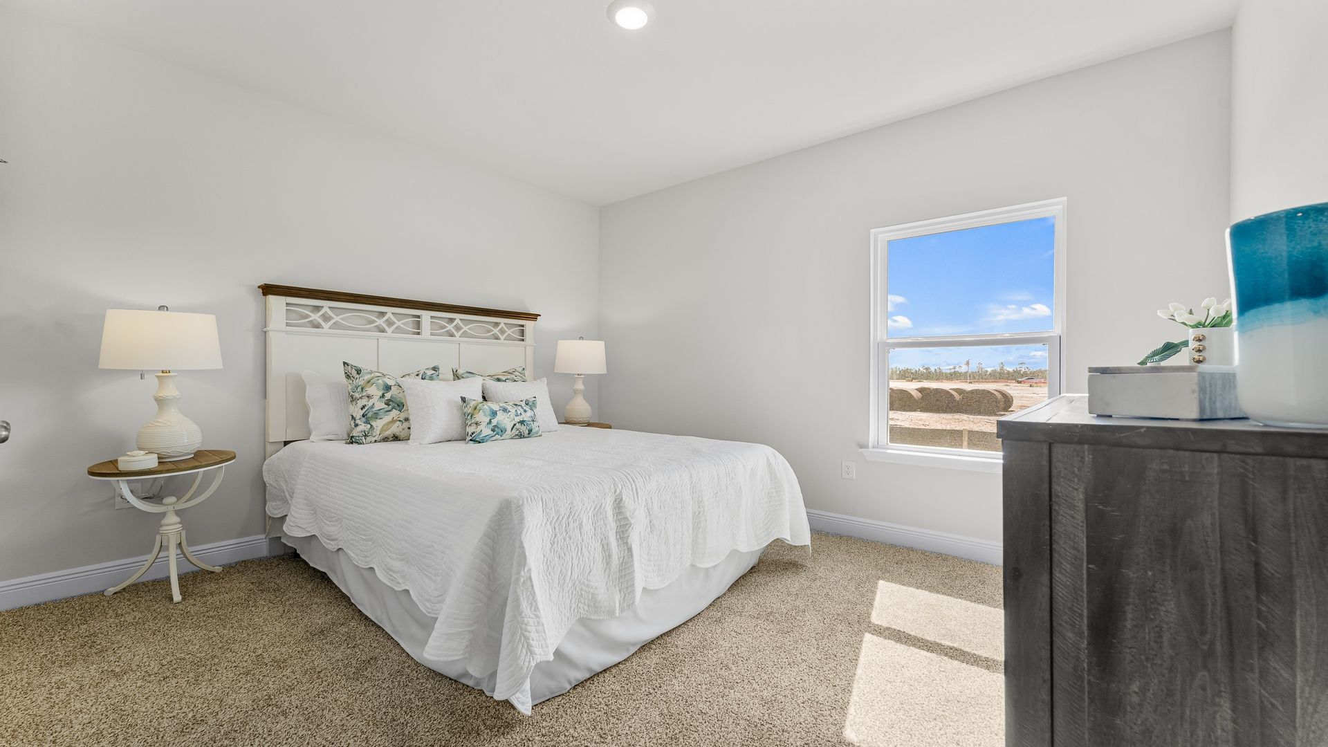 Bedroom four with carpeted floors and windows for natural light.