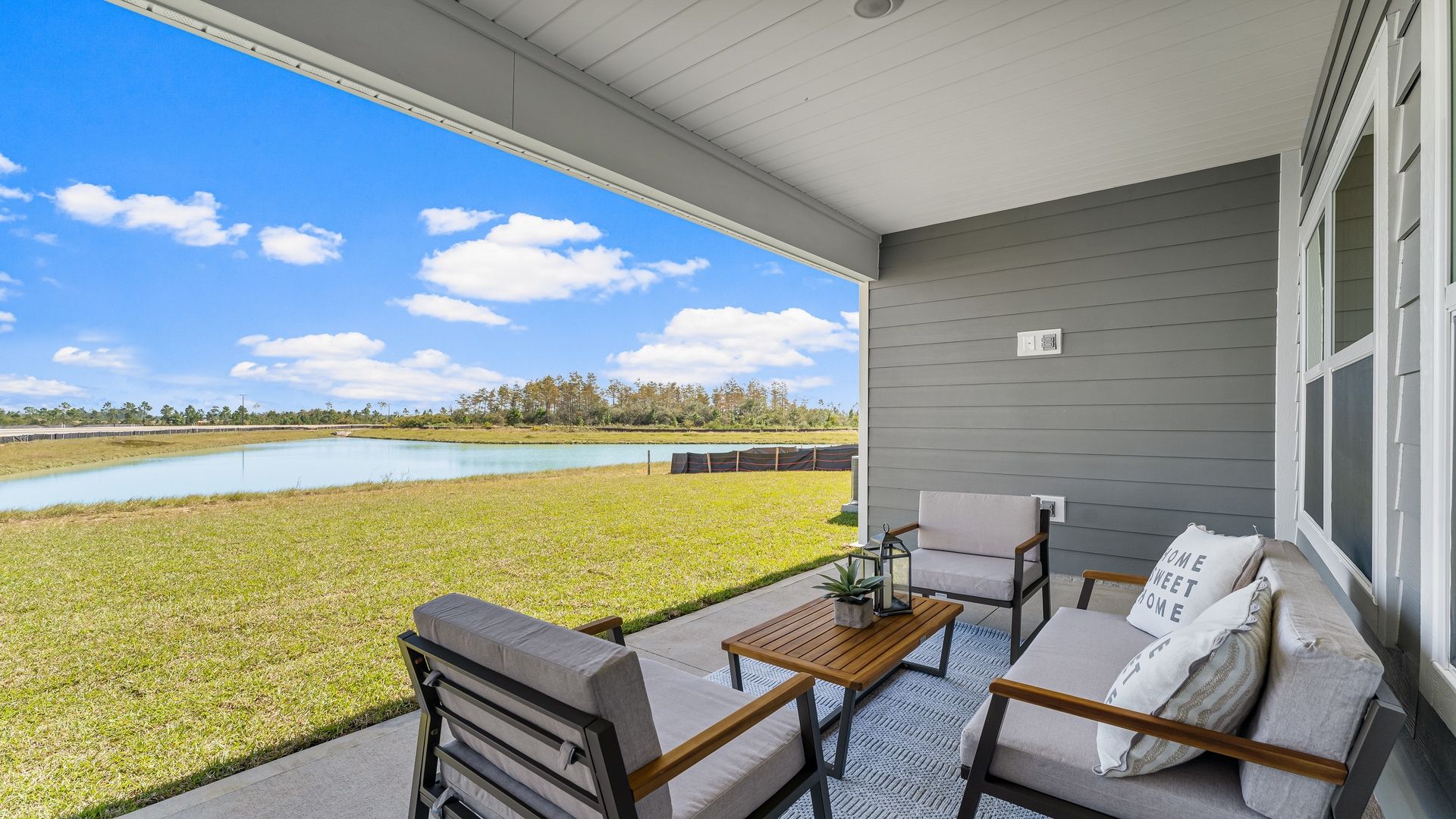 The covered patio opens to greenspace.