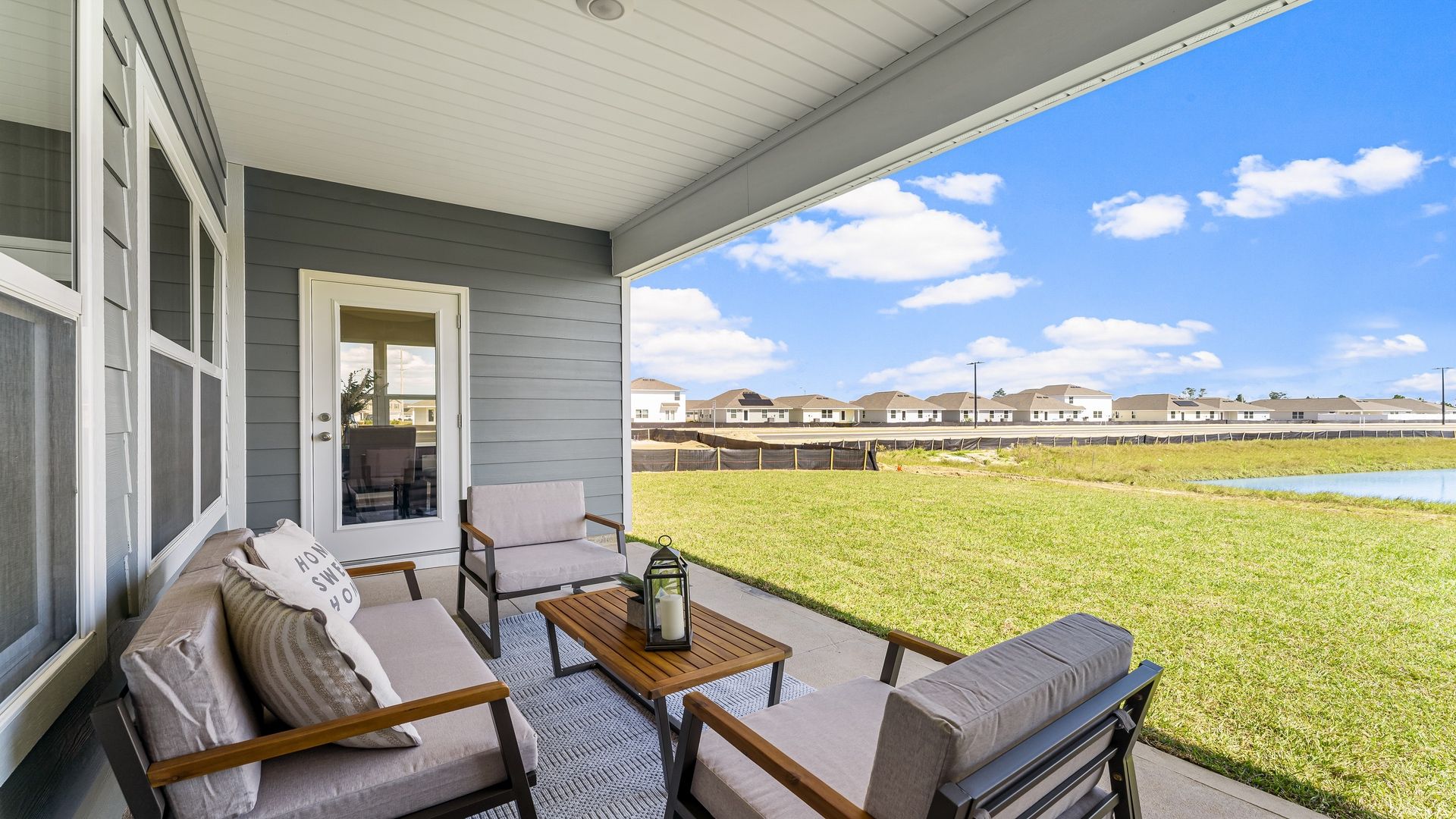 The covered patio opens to greenspace.