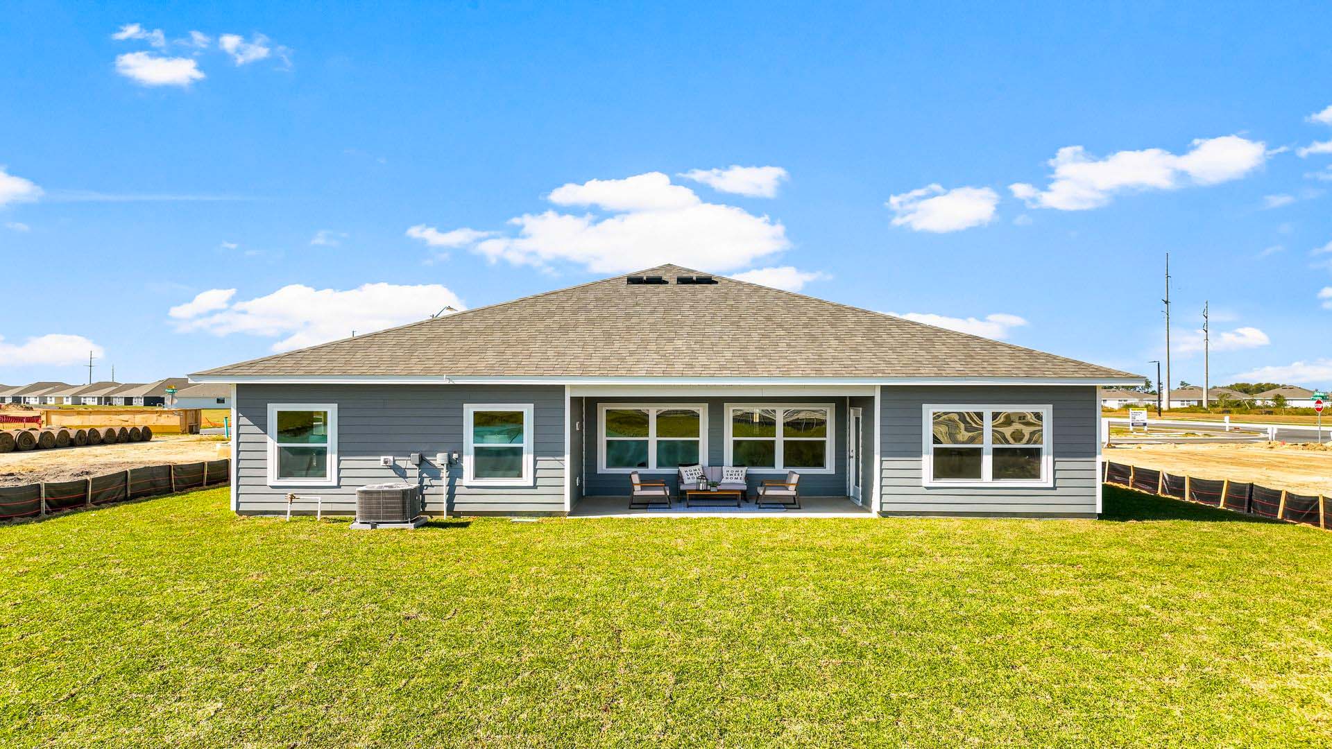 The covered patio opens to greenspace.