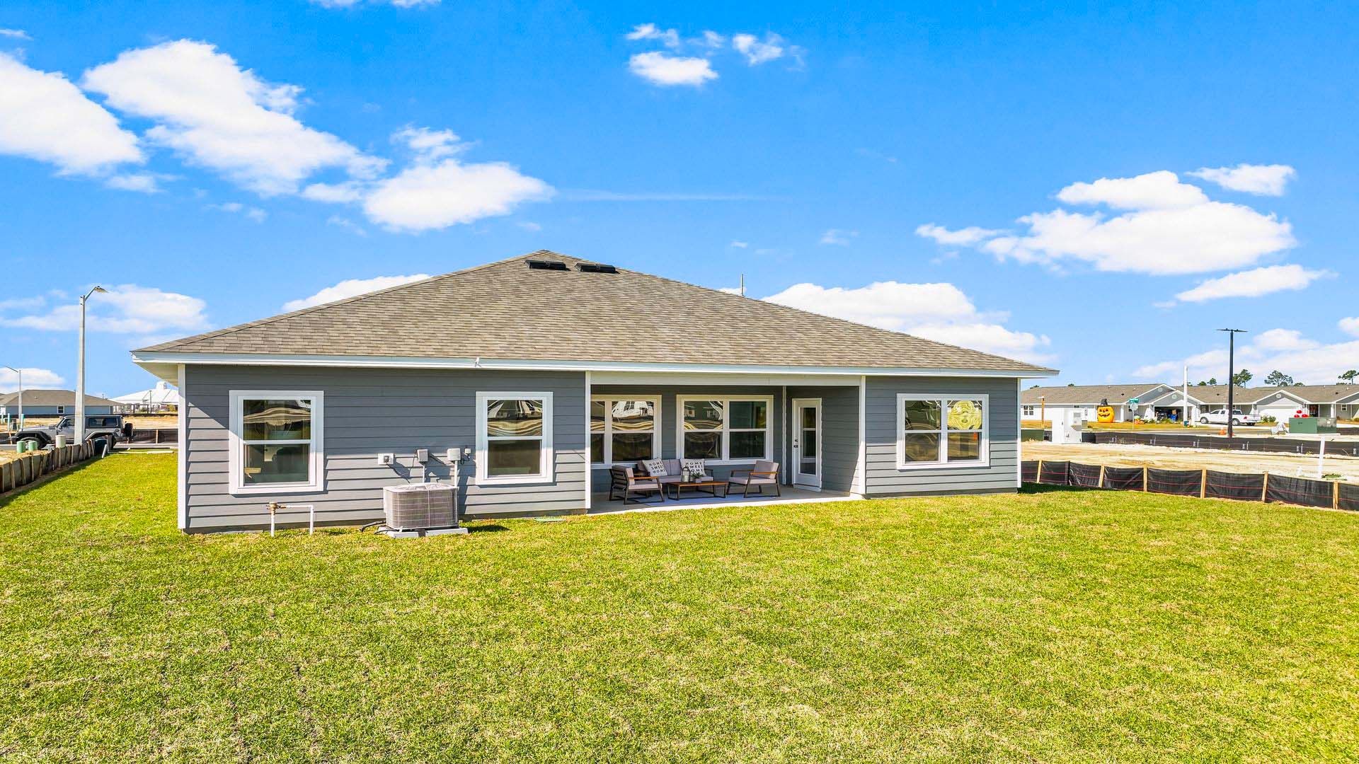 The covered patio opens to greenspace.